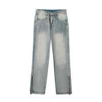 Light wash denim jeans with ankle zippers.