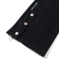 Black pants leg with zipper and snap closures.