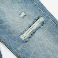 Ripped blue denim jeans.