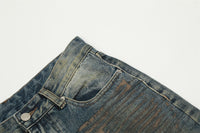 Distressed blue denim jeans.