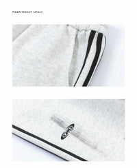Gray sweatpants with black stripes.