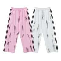 Pink and white striped track pants.